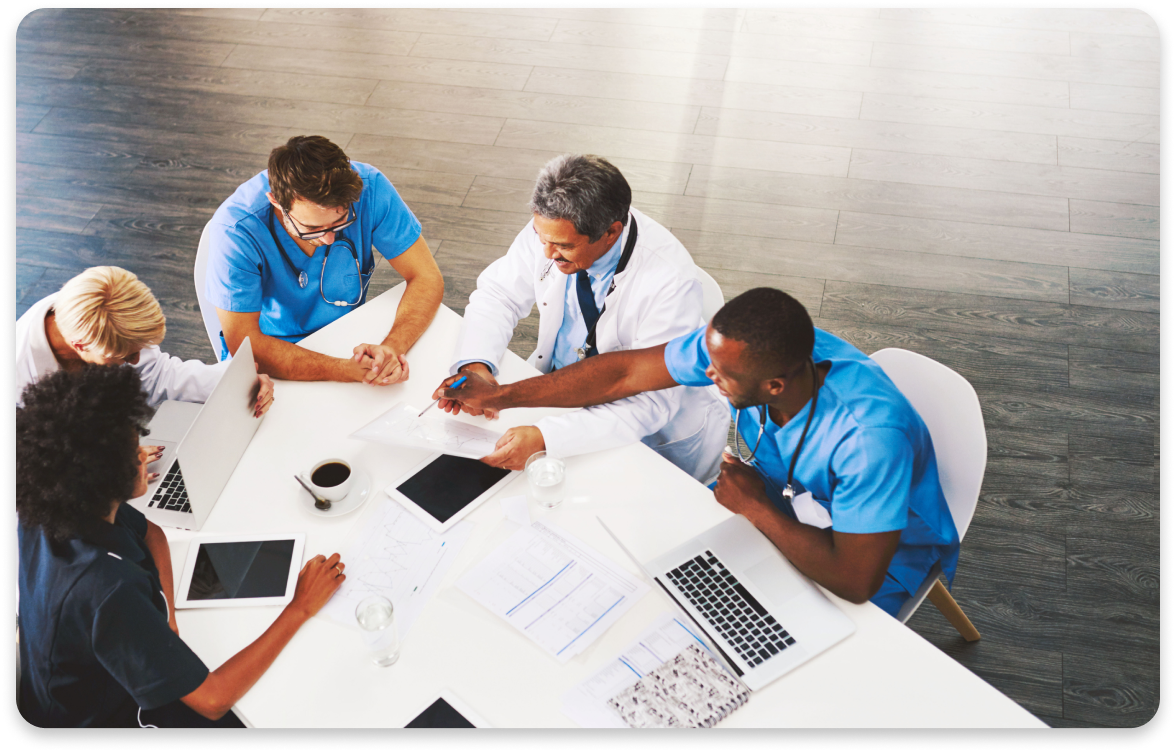 doctors at desk holding meeting